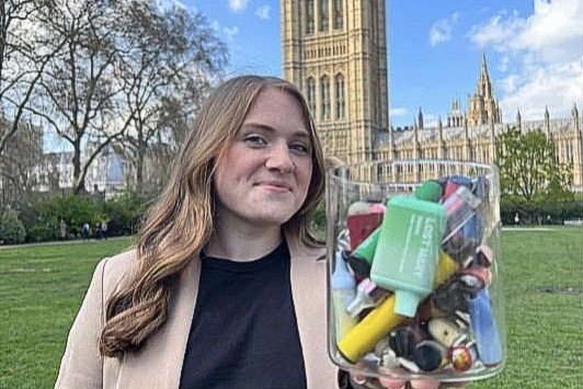 Woman holding disposable vapes